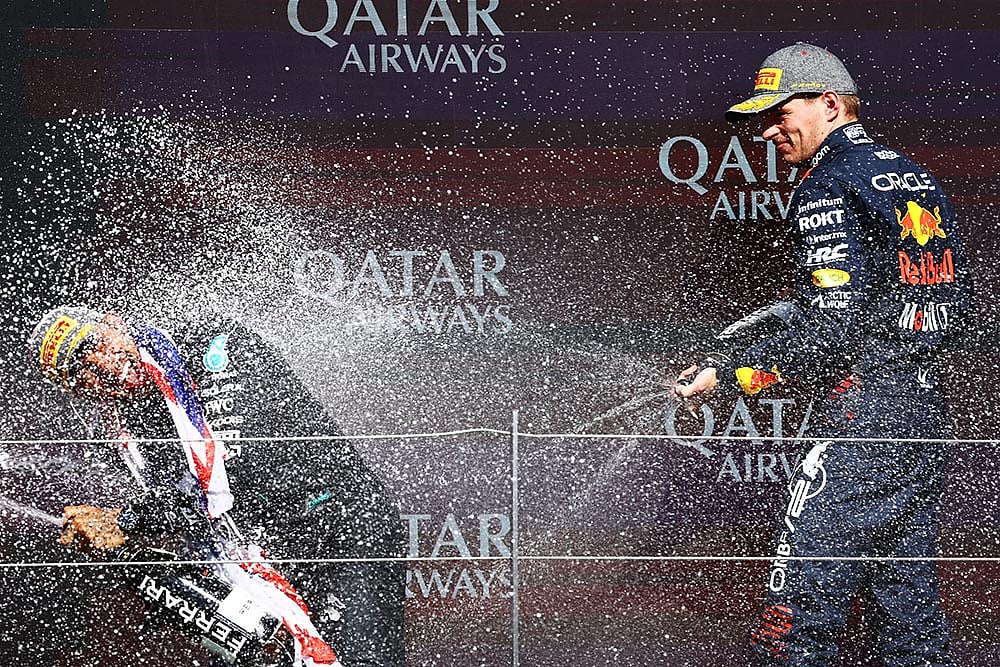 | Photo: Getty Images / Red Bull Content Pool : Second placed Max Verstappen celebrates with Race winner Lewis Hamilton